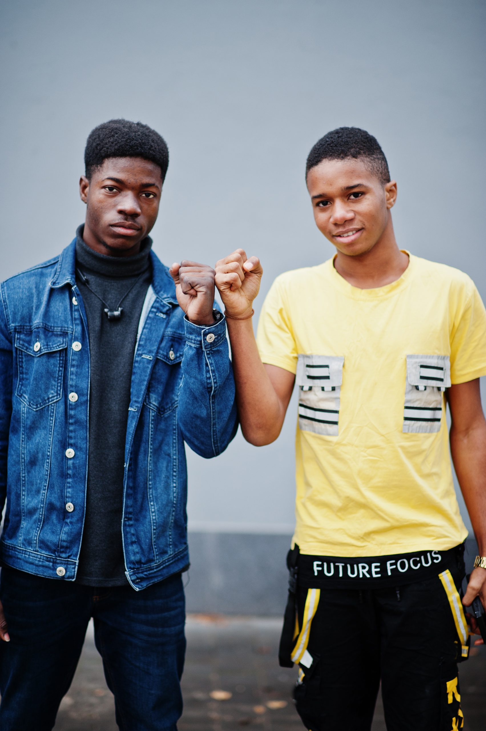 Fist to fist. Two african male friends shaking hands.